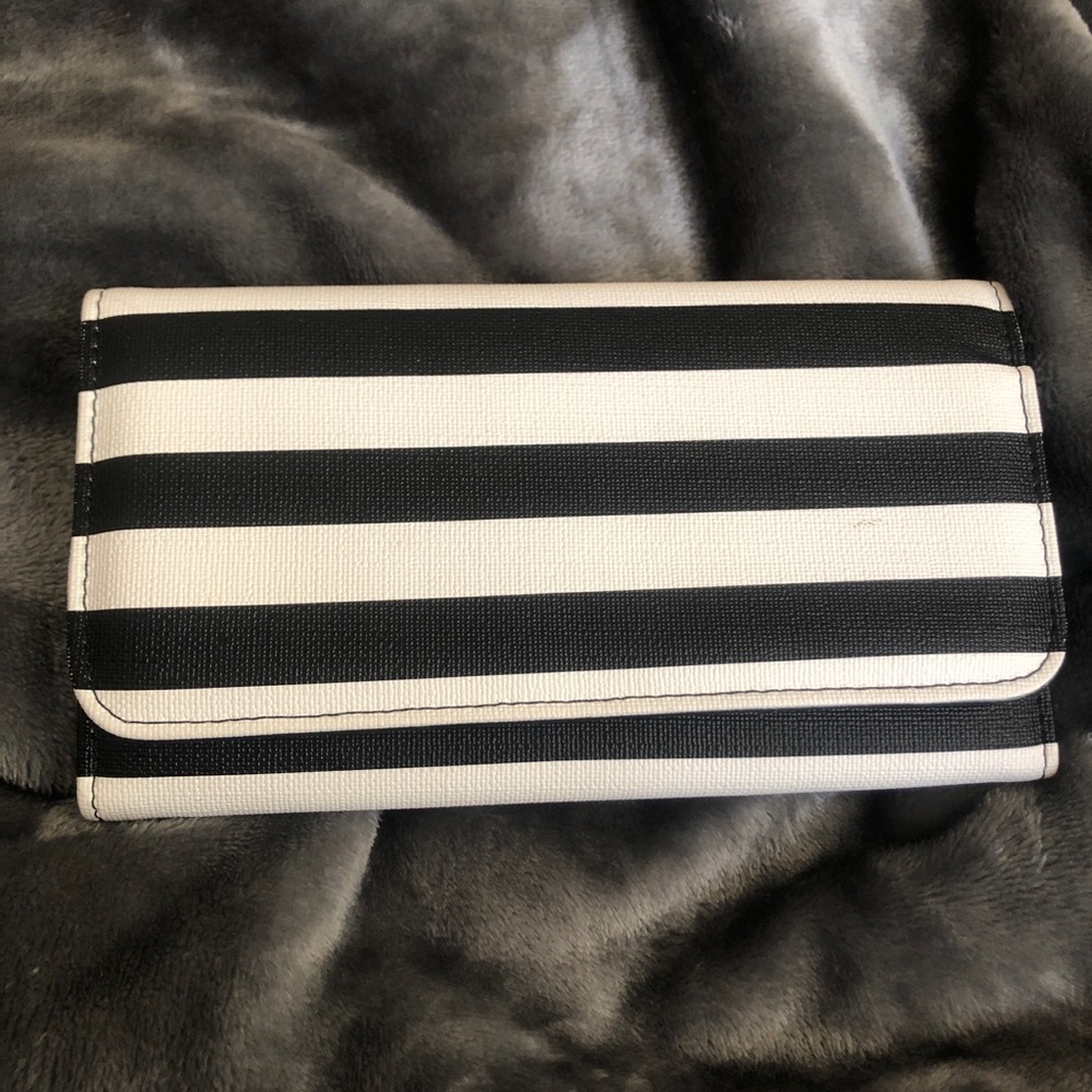 Lightly used black and white stripped clutch